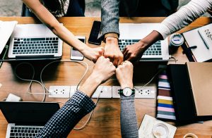 support group of staff fistbumping